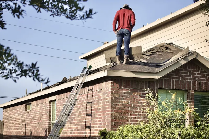 Professional roofer working on a residential roof in Carroll Island